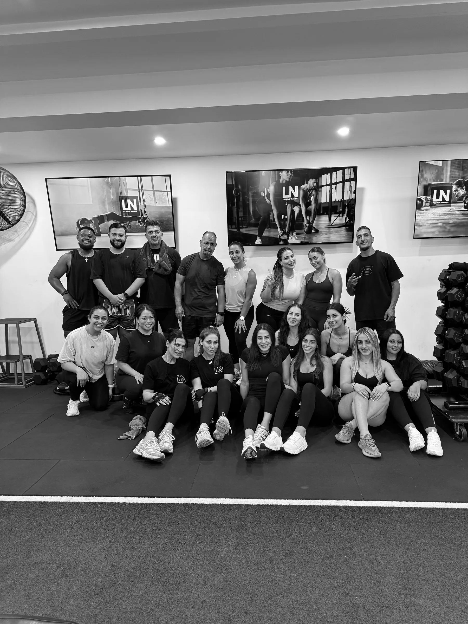 A large mixed group of LNPT members and trainers posing together in the Condell Park studio.