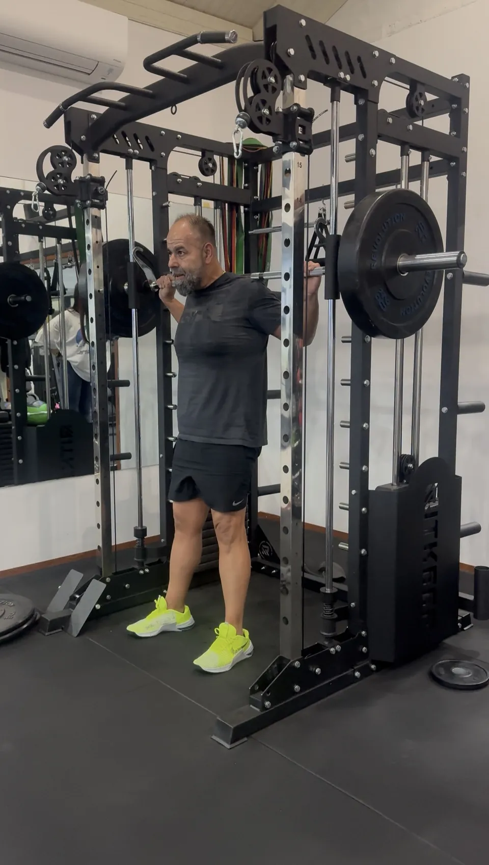 Man performing a squat on a Smith machine at LNPT.