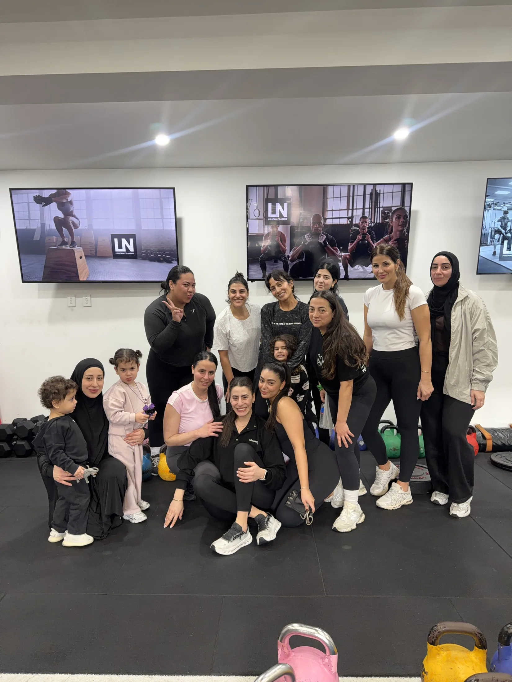 Women and children from the LNPT community gather in the training studio.