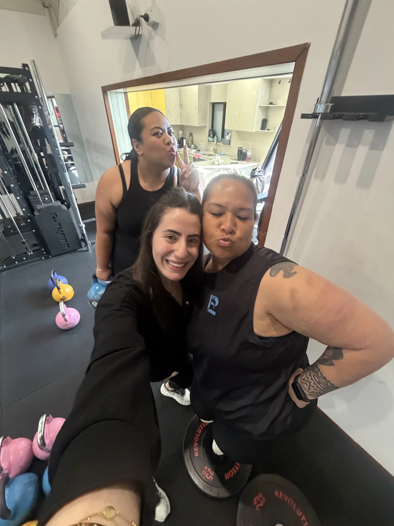 Three LNPT friends share a candid selfie at the gym.